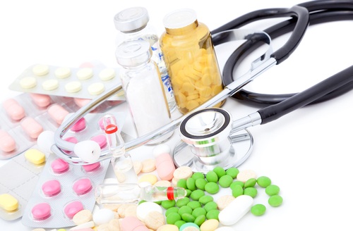 Pharmaceutical Industry Rentals Various medicinal pills and bottles lay next to a stethoscope