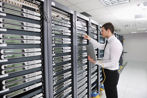 Technology Industry Rentals An IT technician with a laptop plugged into a server