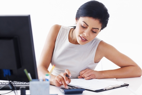 Finance Industry Rentals A woman sitting at a desk using a calculator