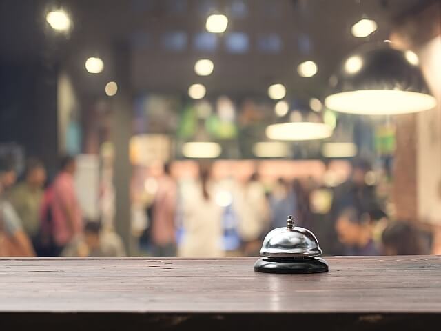 Hospitality Services A service bell on a counter in a busy lobby