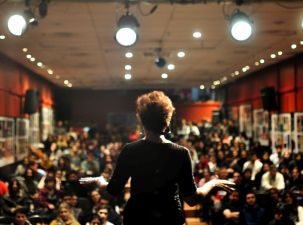 Event Staging and Rigging Service Rentals An individual on stage giving a presentation