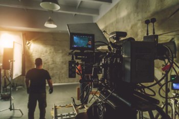 Video Production Rentals A man in front of a production camera on a film set