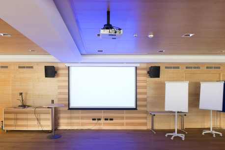 Projector Screen Rentals for Presentations A wall mounted projector screen and two portable projector screens