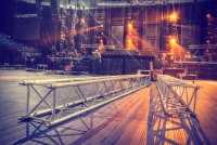 Event Staging and Rigging Services Stage trussing laying on an otherwise empty stage