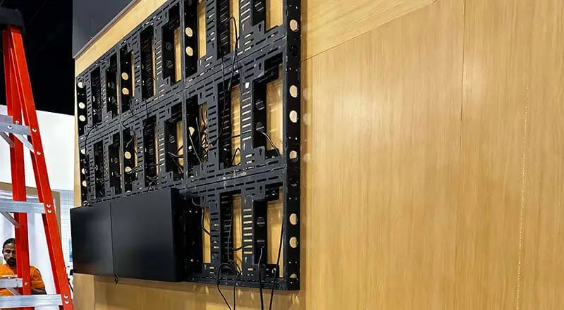 Professional Video Wall Installation A 3x3 video wall in the process of being installed. 2 displays are installed with cabling seen behind the installation