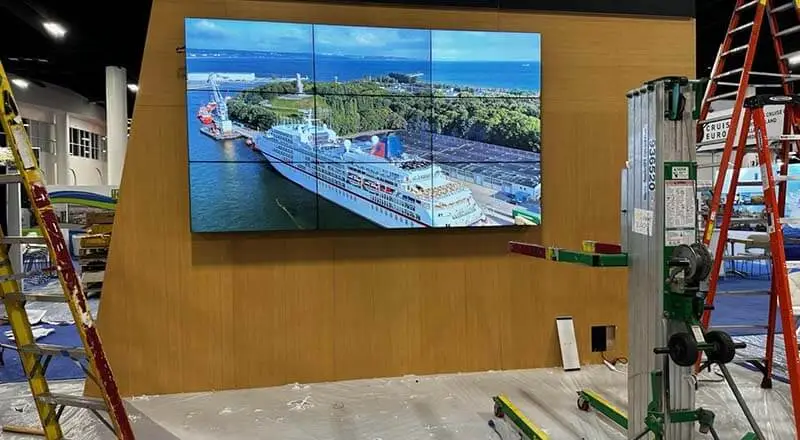 Trade Show Rentals A 3x3 video wall installation during the final phase of testing. All 9 screens are combining to display an image of a cruise ship