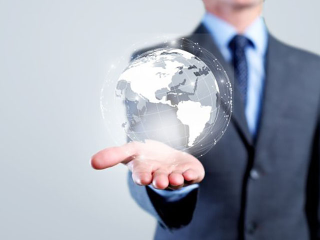 Worldwide Corporate Service A man holding a holographic globe in his hand
