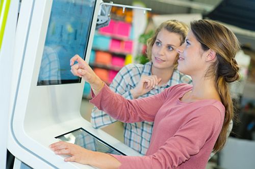 Event Engagement Rentals Two individuals interacting with a touchscreen device at a convention